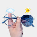 Hand holding blue sunglasses with cloud and sun icons on a white background