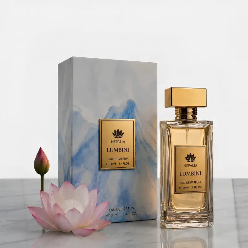 Nepal Lumbini Eau de Parfum bottle and its matching box, styled with a pink lotus flower and a bud on a light marble surface against a white background.