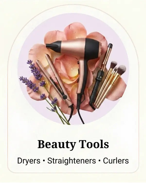 A beauty tools graphic featuring a hair dryer, straightener, curling iron, and makeup brushes arranged on pink rose petals with lavender sprigs inside a circular frame. Text below reads 'Beauty Tools' and 'Dryers • Straighteners • Curlers'.