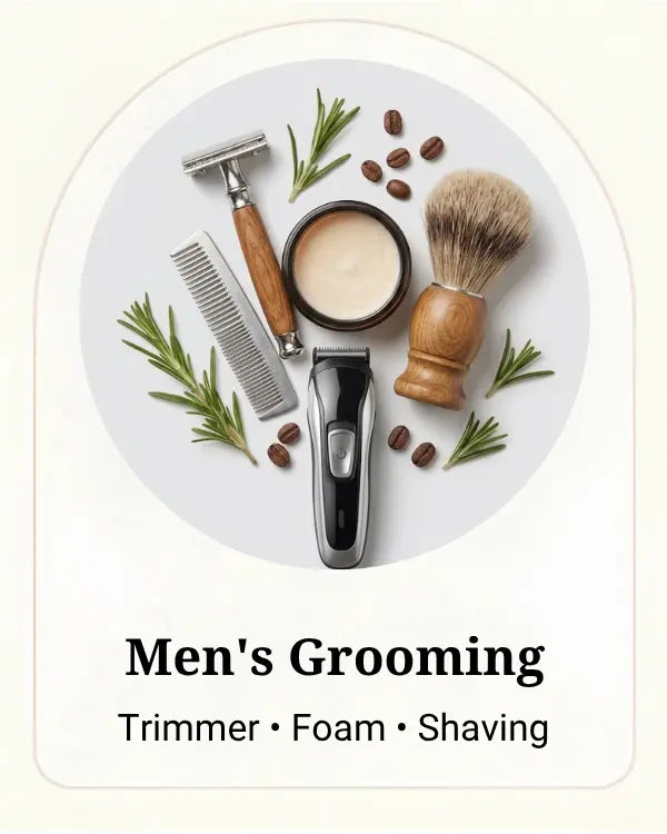 A styled grooming set arranged on a light gray oval background with the text 'Men's Grooming' and 'Trimmer • Foam • Shaving' below. The set includes a trimmer, shaving foam in a jar, a shaving brush, a comb, and rosemary sprigs and coffee beans.